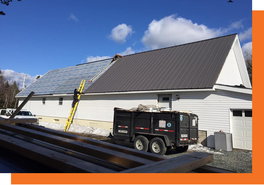New construction home with brown-ish, red metal tiles on its roof